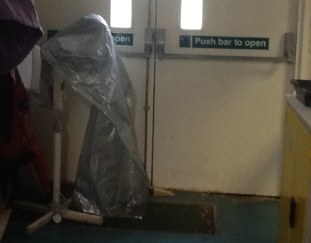 fire exit partially blocked by pedestal fan
