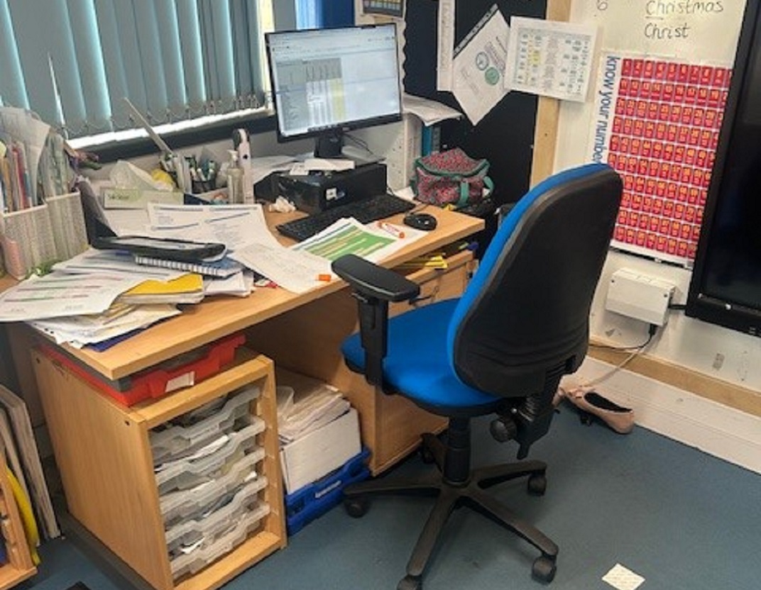 teacher's desk with no space underneath for their legs