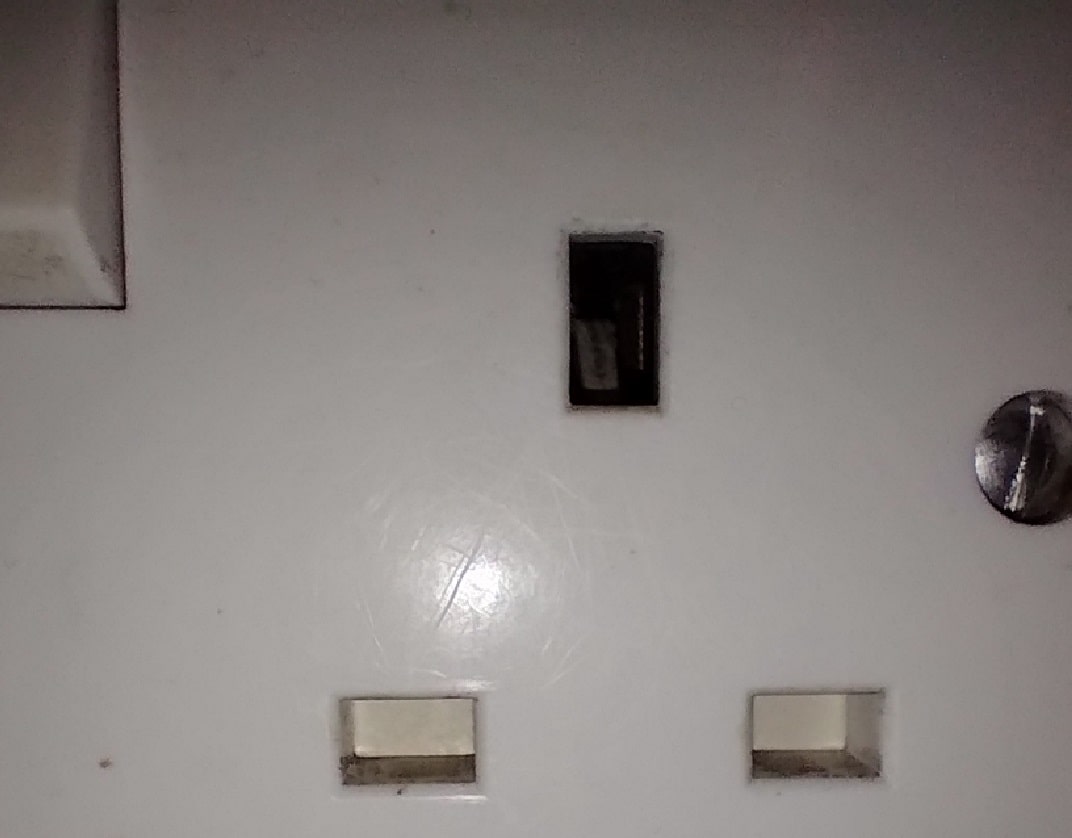 close-up of intact shutters in UK style socket outlet face