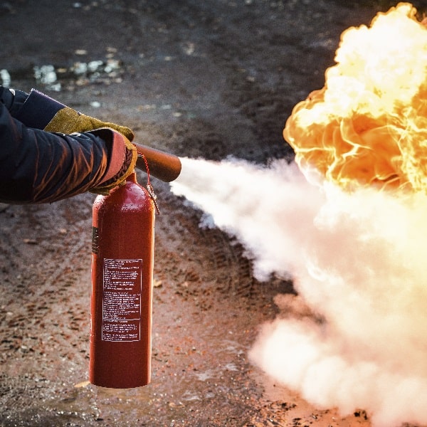 co2 fire extinuisher being used on practice fire