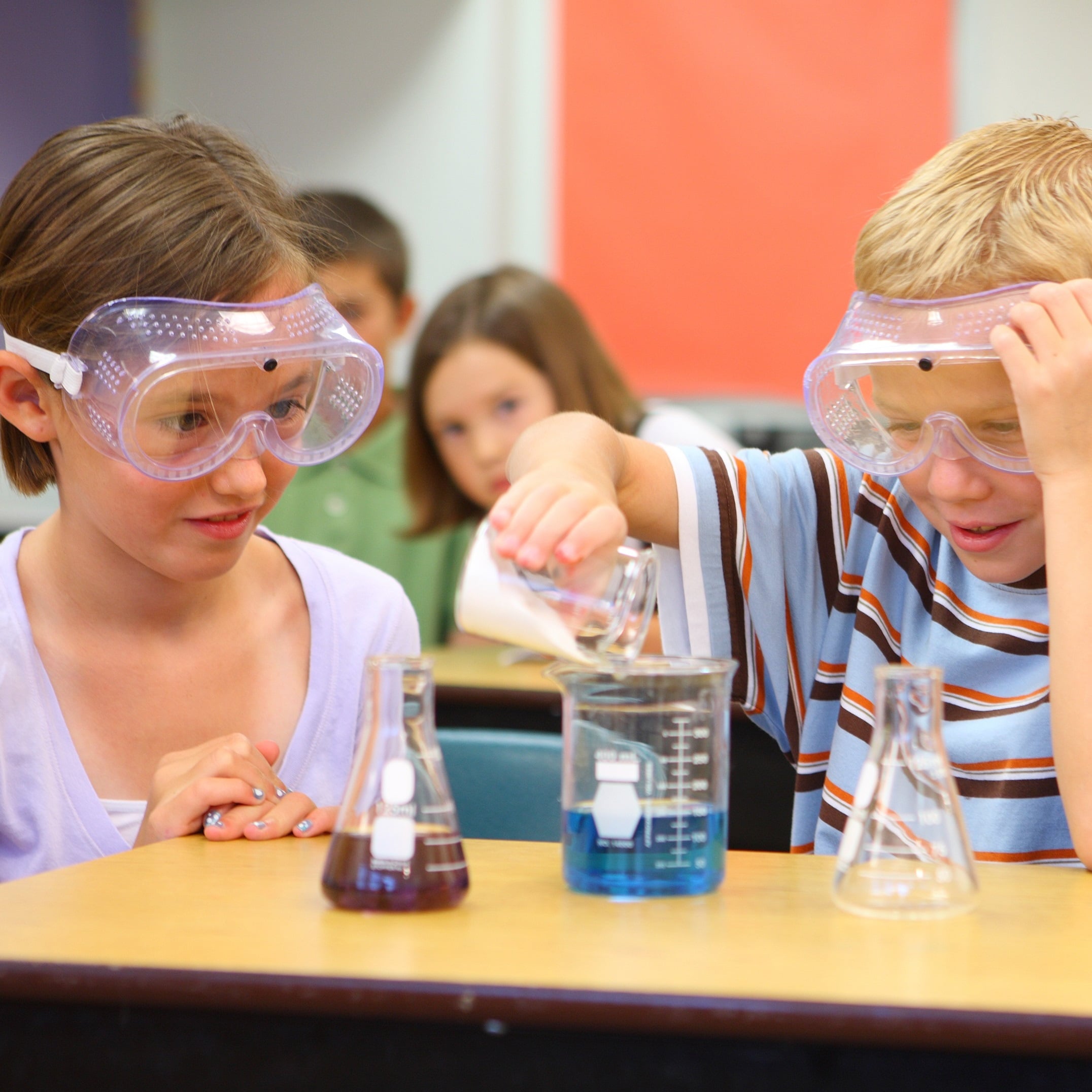 primary children undertaking ascience experiment involving two chemicals